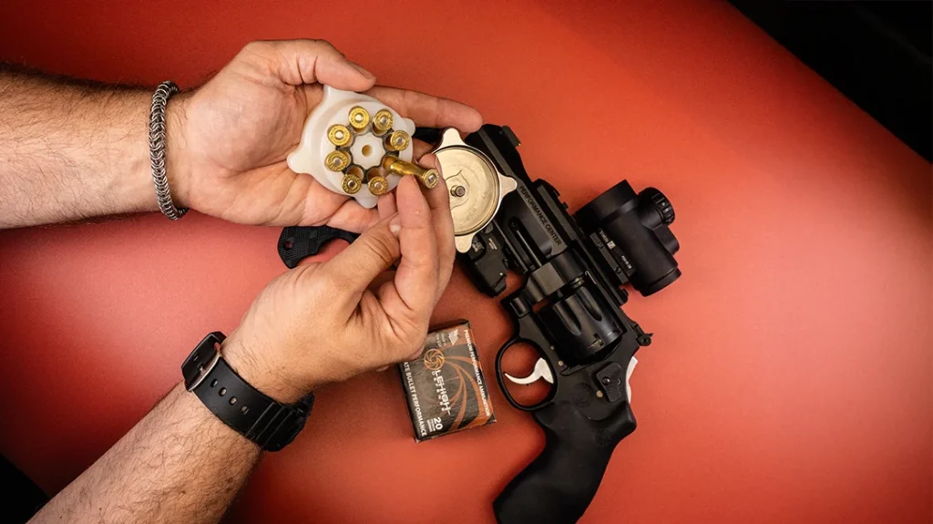 Enter the BMT Mooner. Drop an empty clip in the device, feed cartridges nose-first, set the pawl, and twist.