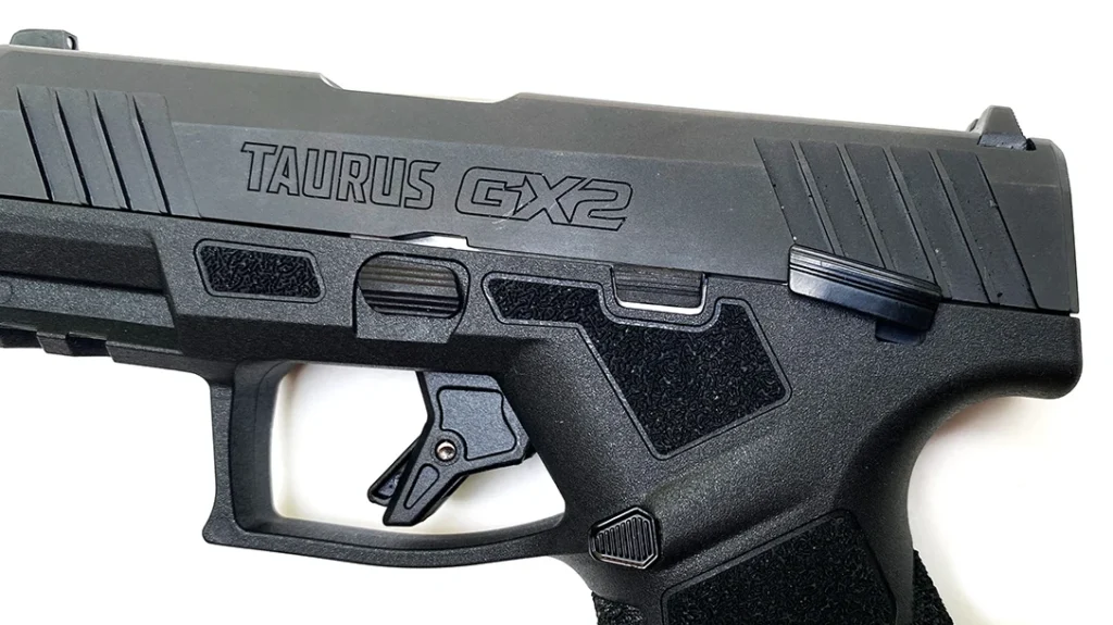 The magazine release button is shielded from the rear by a slight ramp/thumb rest.